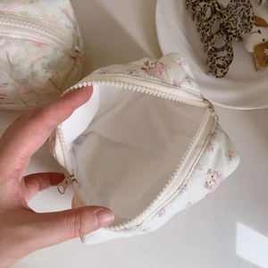 Detail of quilted cotton makeup bag interior with floral print and soft fabric lining