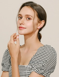 Close-up of elegant s925 silver opal stud earrings worn by a model in a minimal style