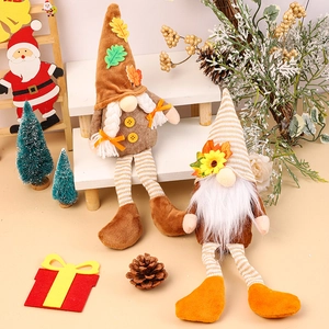 Fall harvest gnomes with maple leaves and sunflowers on white wooden ladder display