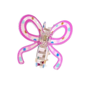 Close-up of butterfly hair claw clip featuring pink borders and colorful polka dots