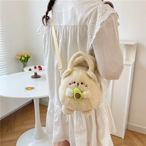 Cute plush avocado cat crossbody bag for girls with adjustable strap in a bright room