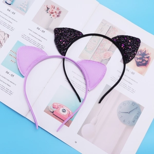 Detail of glittery black cat ears and smooth purple fabric headbands for girls