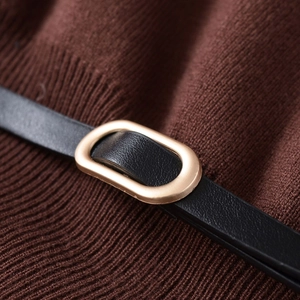 Brown knit top featuring a sleek black leather belt with an oval golden metal buckle