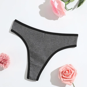 Flat lay of gray ribbed cotton thong with black elastic trim and pink rose decorations