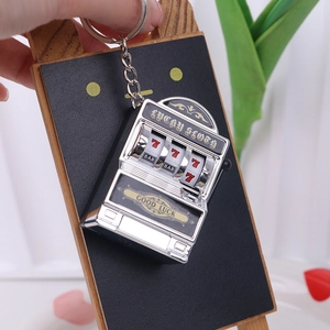 Silver slot machine keychain featuring Lucky Sloth engraving and movable joystick handle