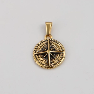 Close-up of golden compass pendant with embossed star and textured nautical rope edge