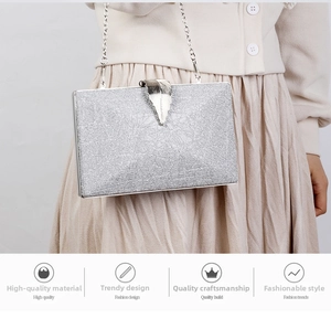 Macro shot of silver sequin evening clutch featuring an elegant leaf-shaped metal clasp