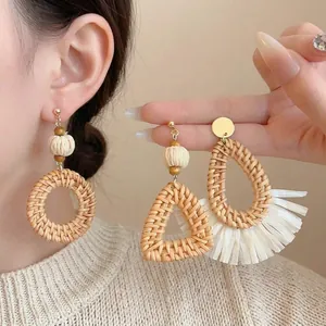 Bohemian rattan drop earrings with straw weaving and tassels for a beach vacation style
