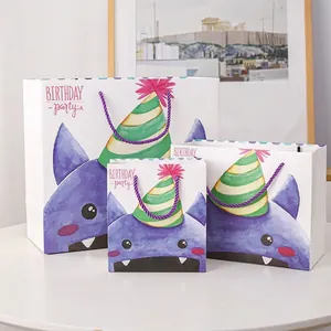 Three sizes of purple monster birthday gift bags with woven handles on white background