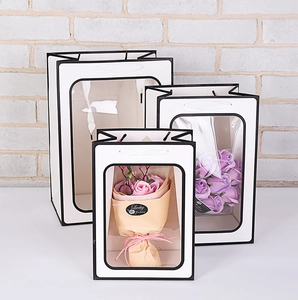 White paper gift bags with clear window and black border in three sizes for presents