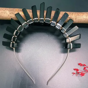 Macro view of crystal headband with raw black stones hand-wired on silver metal frame
