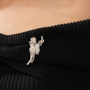 Exquisite silver seahorse brooch with micro-pave white zircons on black knit background