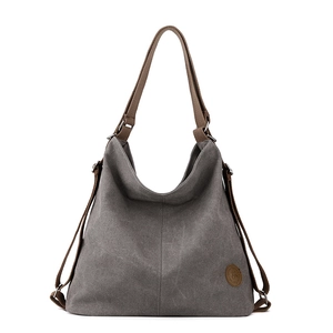 Vintage canvas tote backpack in dark grey with brown straps and logo detail