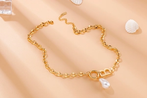 Detail of gold B letter pendant with irregular pearl on O-chain necklace