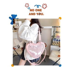 Detailed view of a pink heart-shaped Ita bag with clear display window for pins and badges