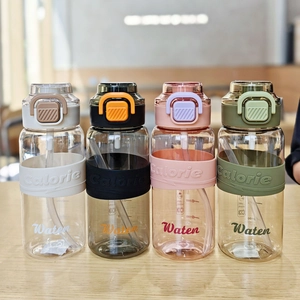 Detail of four colorful sports water bottles with silicone sleeves and calorie scales