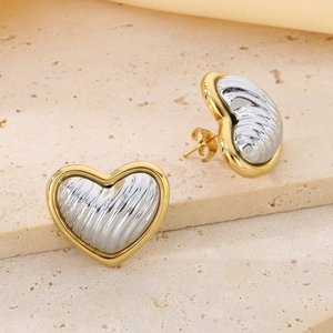 Detailed view of heart stud earrings with two-tone 18K gold plating and ribbed texture