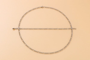 Close-up of silver Figaro link chain necklace set with polished stainless steel texture