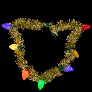 Macro shot of heart-shaped Christmas garland with gold tinsel and glowing colored bulbs