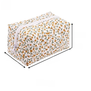 Detail of floral makeup bag featuring yellow flowers, white zipper and cotton fabric