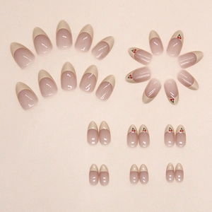 French almond press-on nails with cream nude base and sweet red cherry patterns