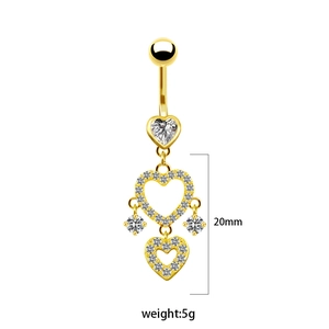 Detailed view of golden heart-shaped belly ring with multi-layered zircon crystal pendants