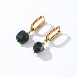Detail of minimalist gold U-shaped earrings featuring dark marble stone drops