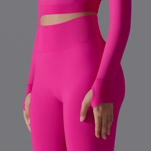Detail of rose red seamless ribbed yoga set featuring thumbhole cuffs and high waist