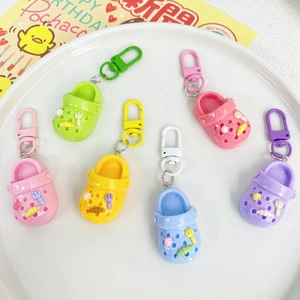 Close-up of colorful mini garden clog keychains in green, yellow, pink and blue