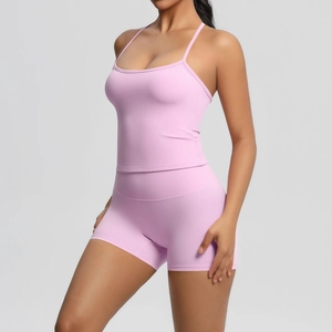 Detailed view of pink yoga set with spaghetti strap tank top and high-waist biker shorts