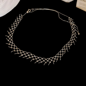 Macro detail of silver woven lace necklace with micro-pave crystals on black background