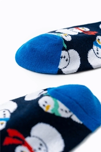 Detail of blue Christmas socks showing snowman pattern and fine knit toe stitching