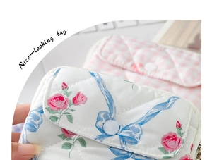 Close-up of quilted floral and plaid mini storage pouches with snap and zipper details