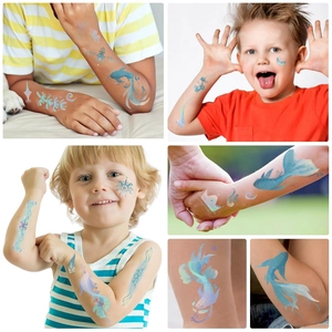 Close-up of glitter ocean themed temporary tattoos featuring sea horses and fish on skin