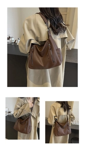 Close-up of vintage brown leather tote bag with unique double zipper and fringe details