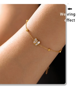 Wearing effect of golden butterfly bracelet with mother of pearl and zircon stones