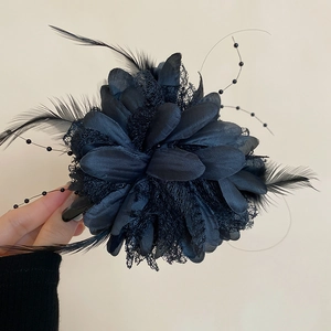 Detailed view of elegant black lace flower hair clip with feathers and beads decorations