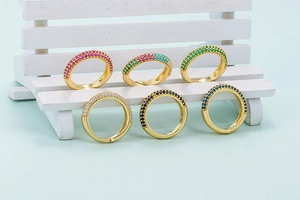 Set of six colorful zircon rings in gold plating with pavé setting on a white miniature bench