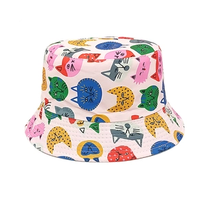 Detailed view of pink cotton bucket hat featuring colorful cartoon cat face prints