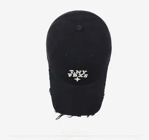 Close-up of distressed vintage black cotton baseball cap with white embroidery