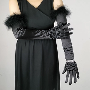 Detail of black satin long gloves with elegant feather trim and rhinestone accents