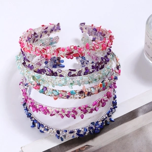 Five colorful stone headbands with beads and crystals on a clean white background