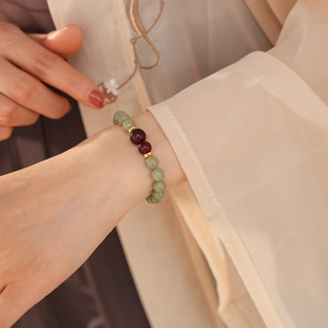 Close-up of retro Chinese style Hetian jade beaded bracelet worn on a woman wrist