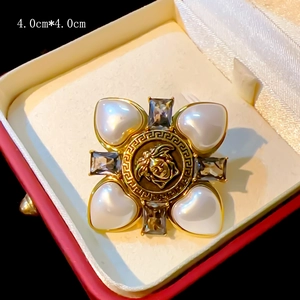 Detail of 4.0cm vintage pearl brooch with Medusa head motif and clear crystal accents