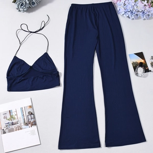 Flat lay of navy blue two-piece set featuring a halter crop top and wide-leg trousers