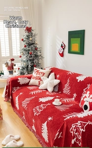 Close-up of red Christmas sofa throw blanket with white tree pattern and fringe