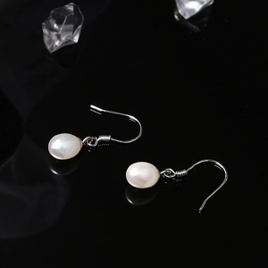 Elegant S925 sterling silver natural pearl drop earrings on black reflective surface