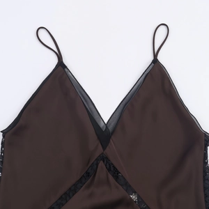 Close-up of deep brown satin camisole with black lace trim and delicate v-neckline