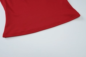 Detail of red knitted fabric with high-quality double-needle stitching on the garment hem