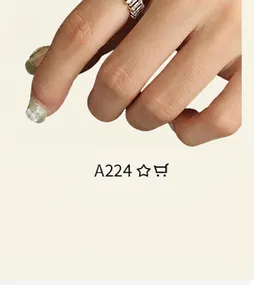 Macro detail of gold plated brass ring with rectangular zircon pave on a model's finger